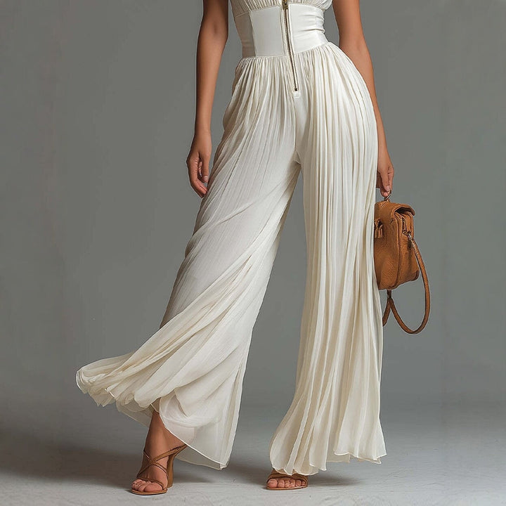 Tuta in chiffon bianca senza maniche con scollo a V, zip e pantaloni a gamba larga plissettati